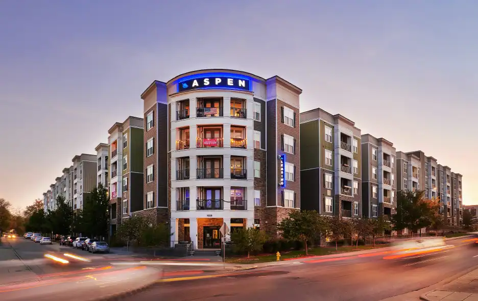 Modern Aspen apartment building with colorful balconies and city street view.